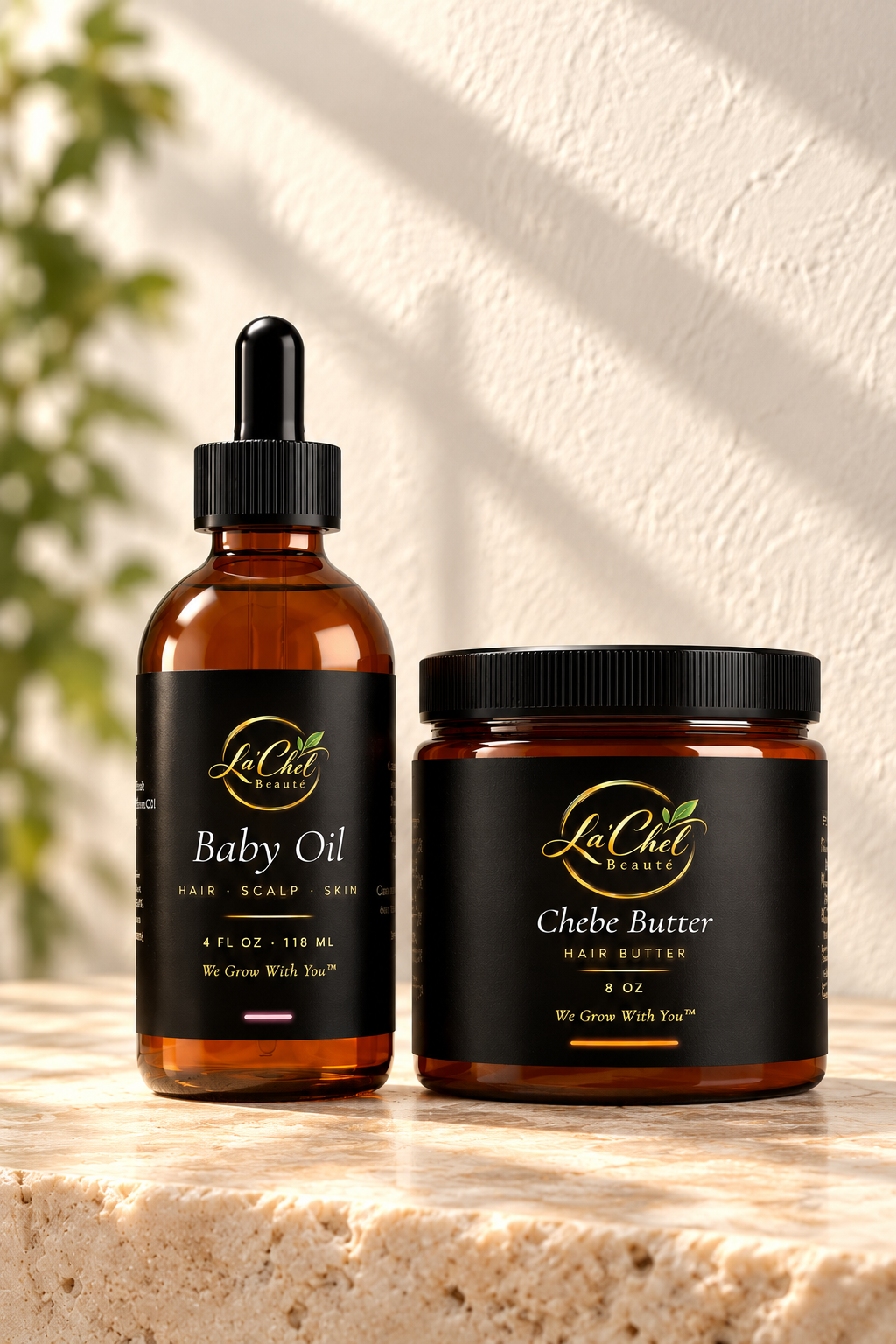 La'Chel Beauté Baby Oil 4 oz and Chébé Butter 8 oz on a sunlit stone counter